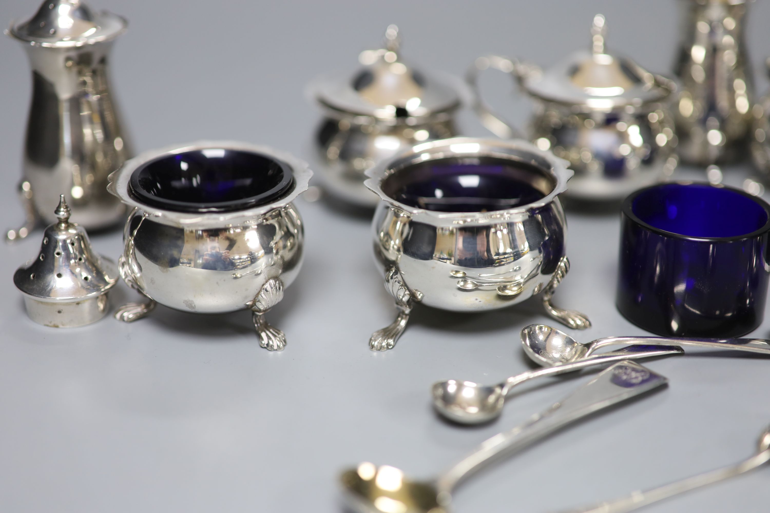 An Edwardian six piece silver condiment set and five other assorted silver condiments.